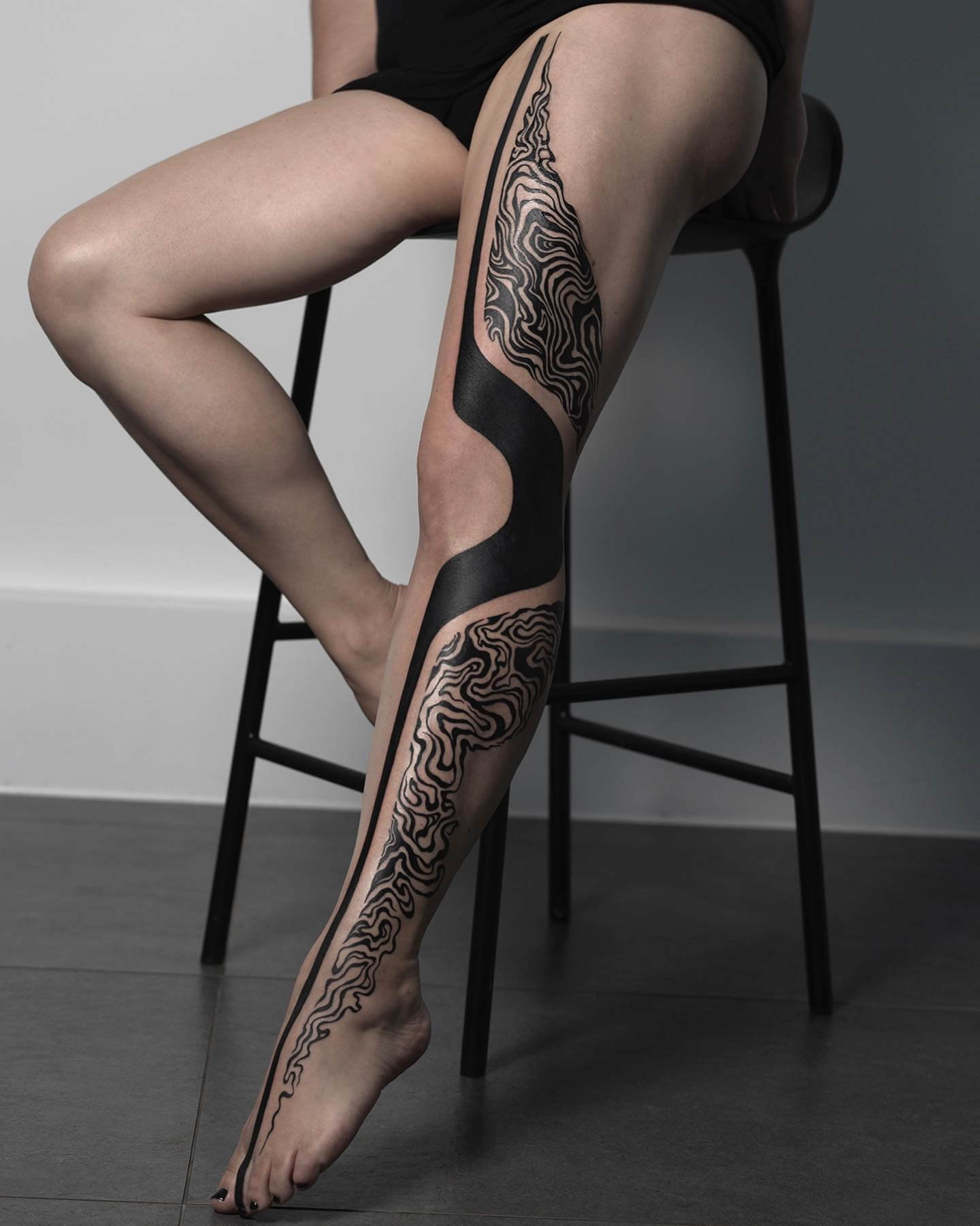 blackwork leg tattoo