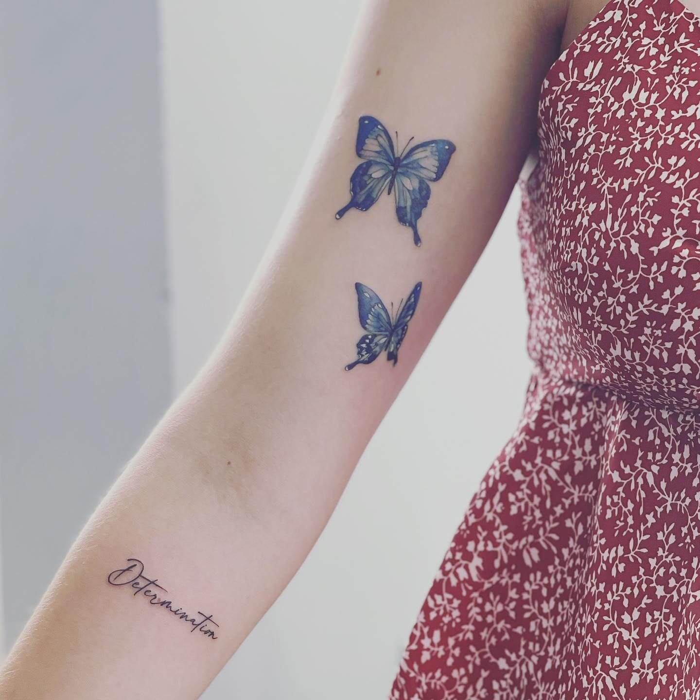 blue butterfly hand tattoo