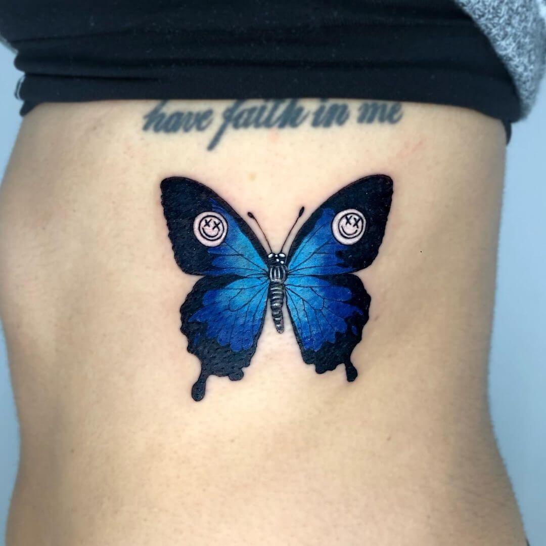 blue butterfly rib tattoo