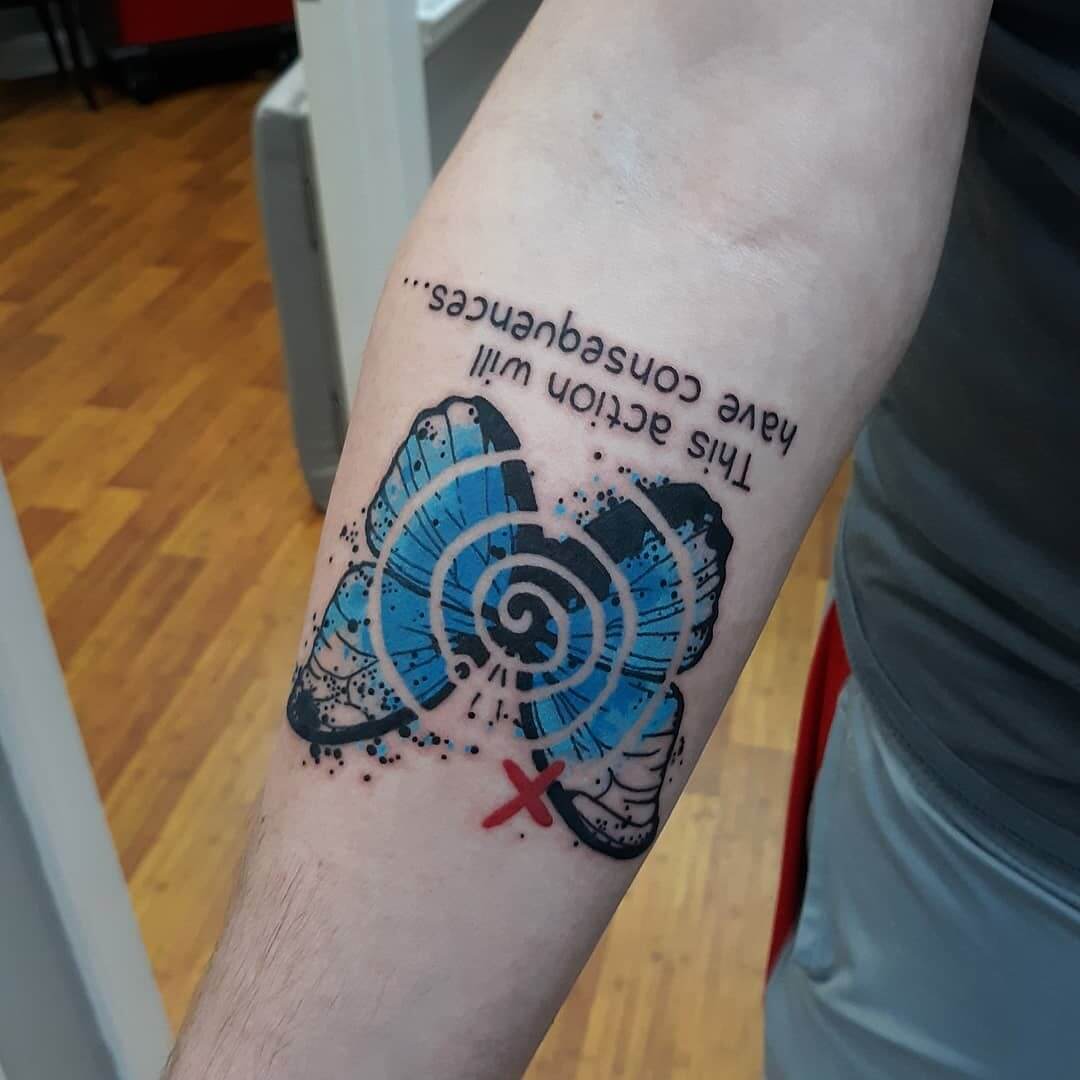 blue butterfly tattoo on arm