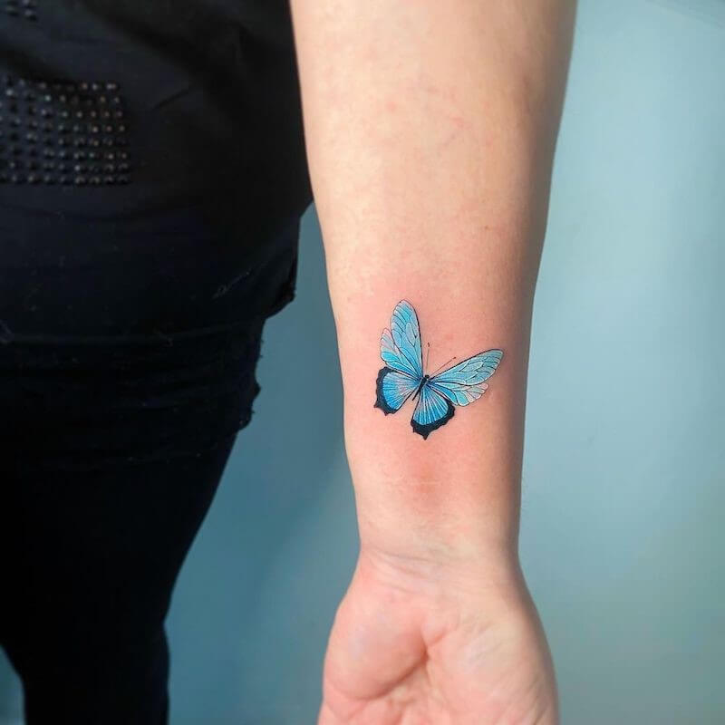 blue butterfly tattoo on wrist