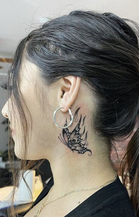 butterfly skull neck tattoo
