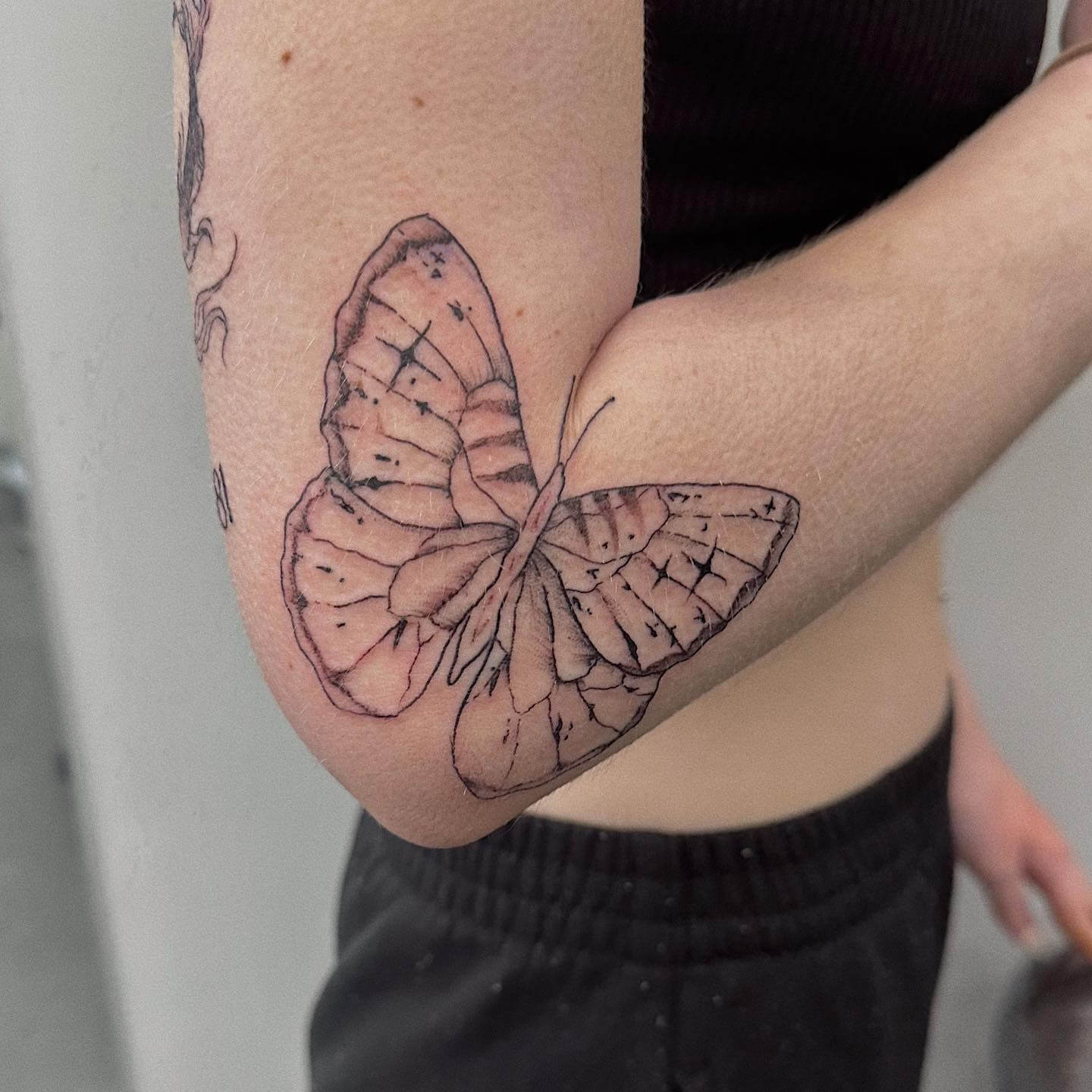 butterfly tattoo on hand and arm