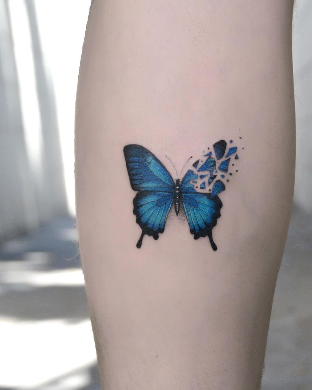 Dark blue butterfly tattoo