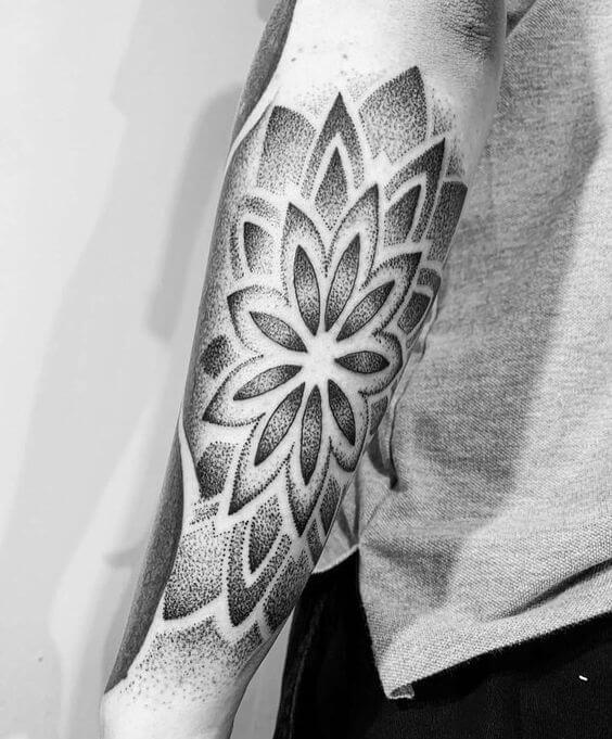dotwork tattoo mandala on arm.