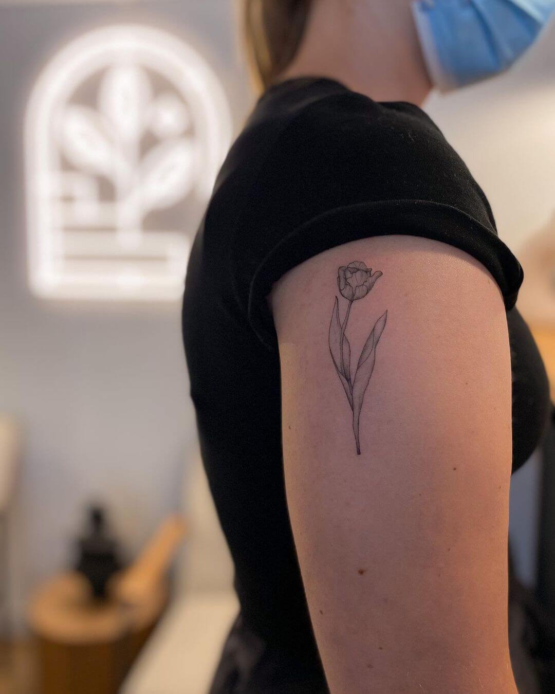 fine line flower back tattoo.