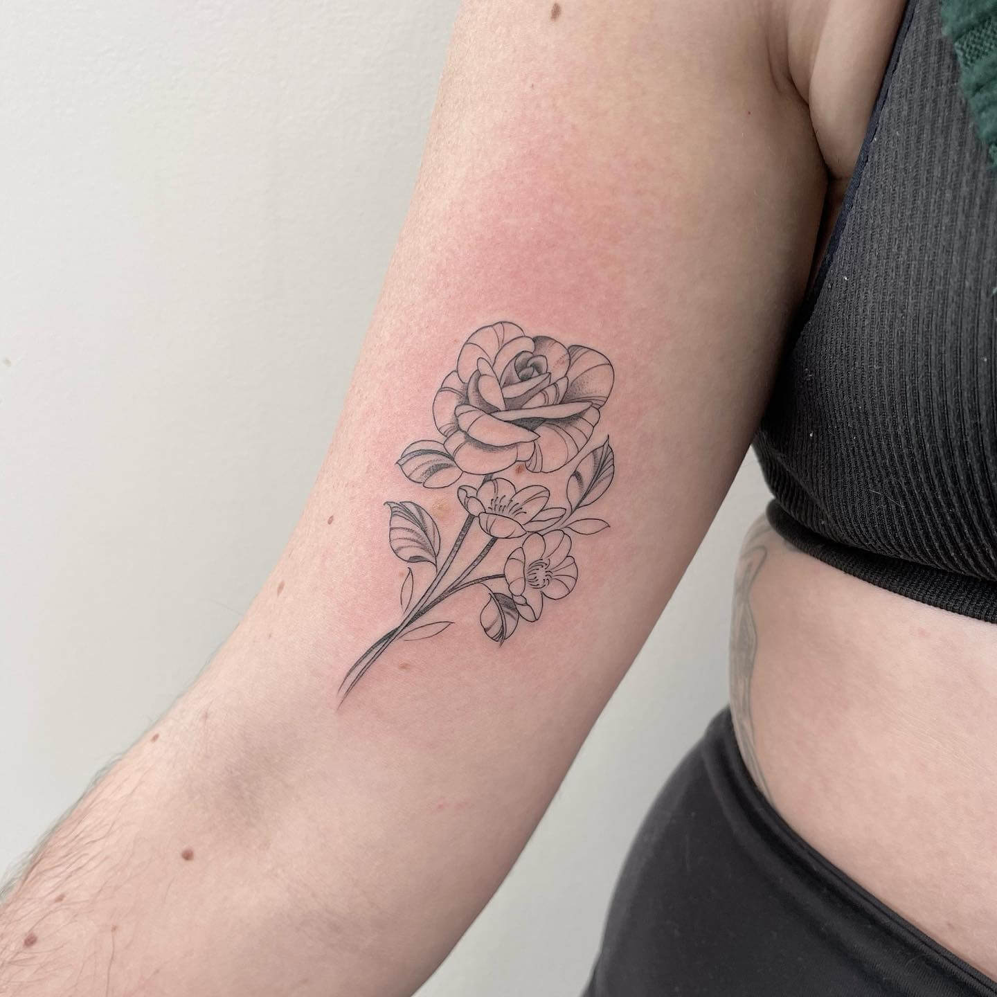 fine line flower tattoo shoulder.