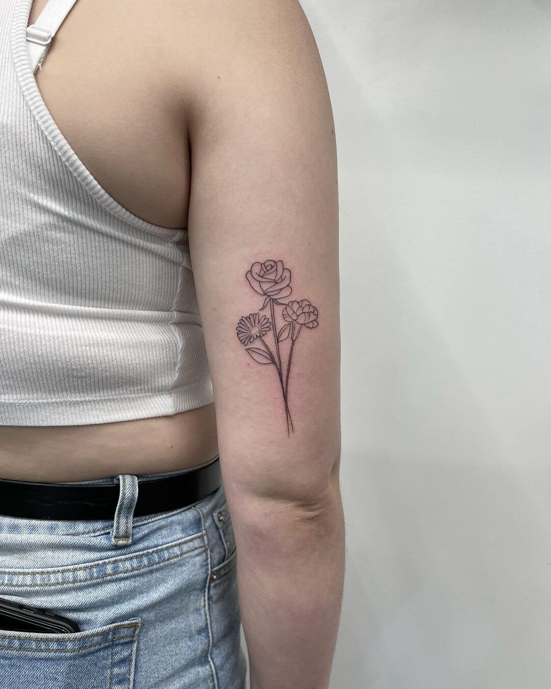 fine line wild flower tattoo.