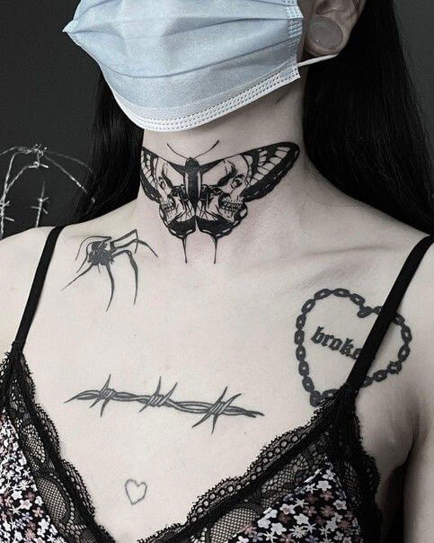 Butterfly front neck tattoo with different symbols