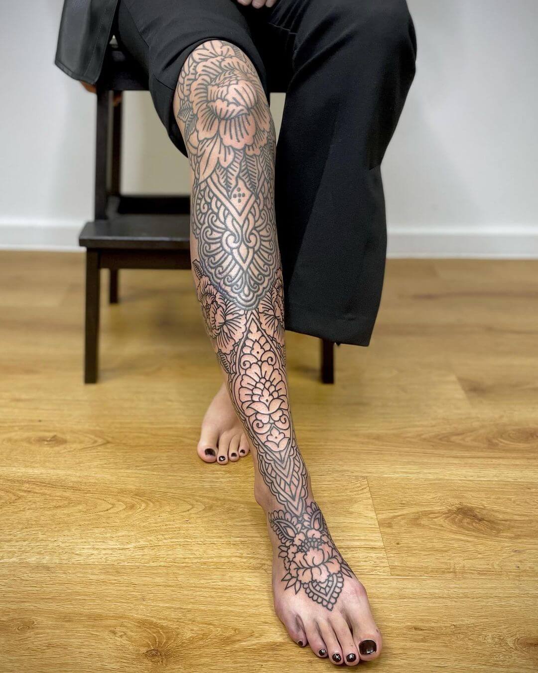 ornamental flower tattoo leg