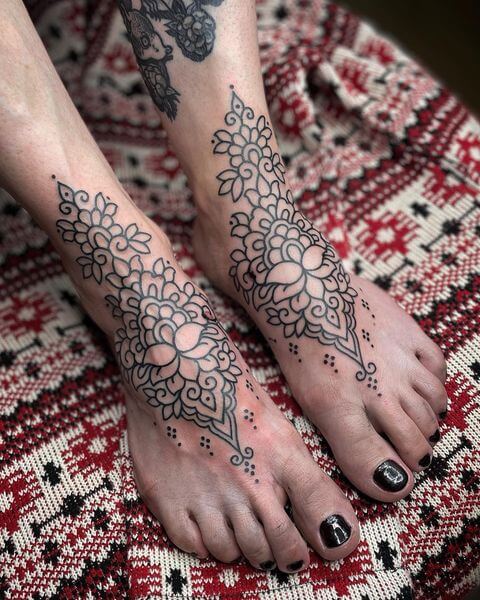 ornamental flower tattoo legs