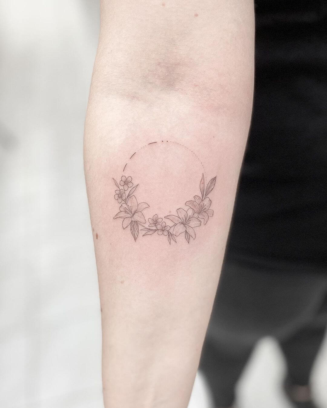 small fine line flower tattoo.