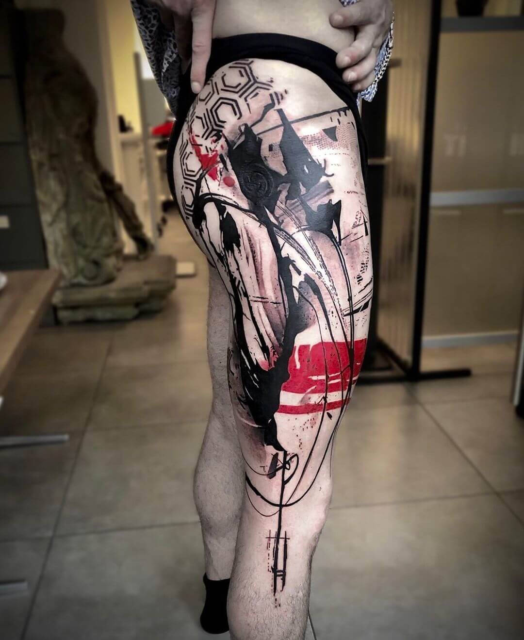 trash polka tattoo on leg.